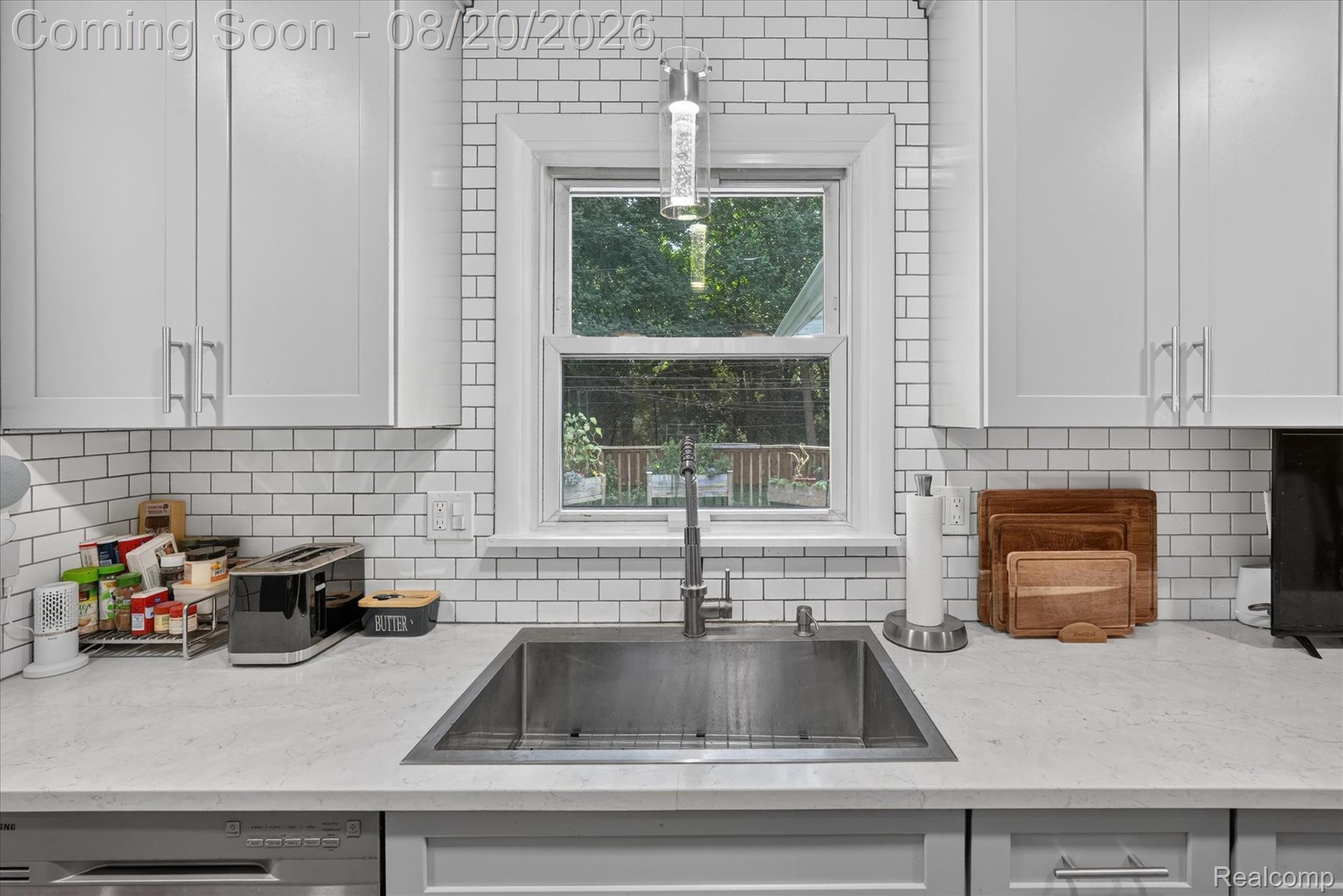 6235 Waldon Road Clarkston, MI 48346 - Photo 9 of 41 White shaker-style cabinetry, subway tile backsplash, stainless steel under-mount sink, chrome faucet, and light-toned countertop