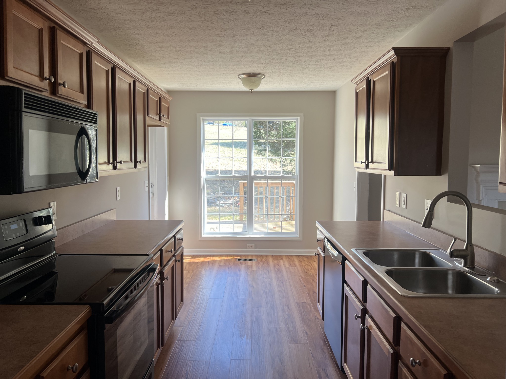 192 Wilkinson Road Cottontown, TN 37048 - Photo 5 of 20 a kitchen that has a sink a stove and wooden floor