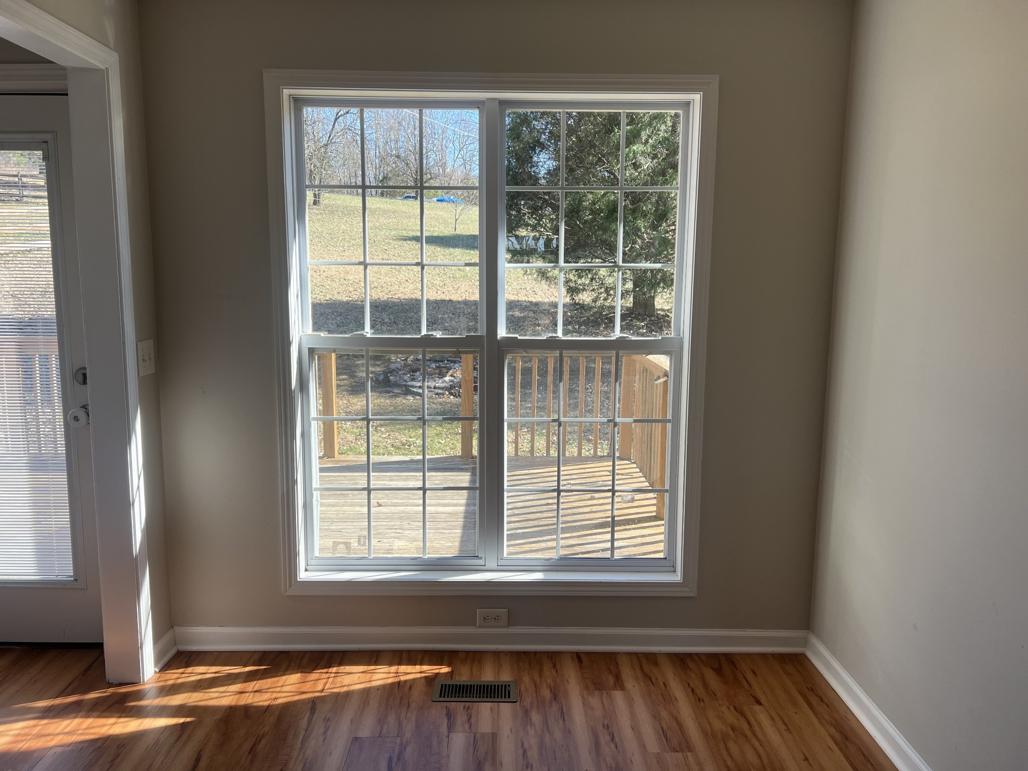 192 Wilkinson Road Cottontown, TN 37048 - Photo 6 of 20 a view of an empty room with wooden floor and a window