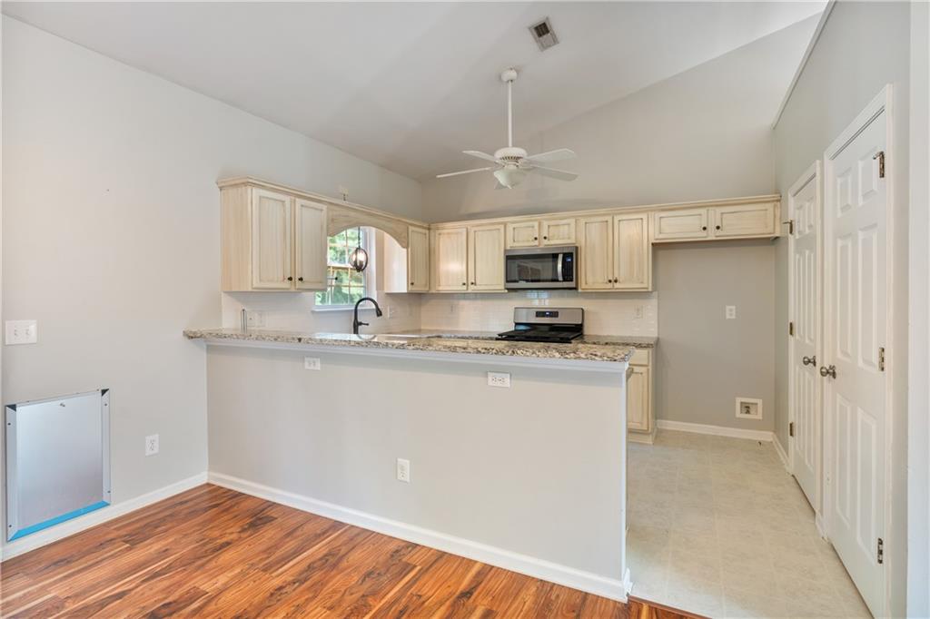 14 Bryan Springs Road Southwest Rome, GA 30165 - Photo 11 of 40 a kitchen with kitchen island granite countertop stainless steel appliances cabinets a sink and a counter top space