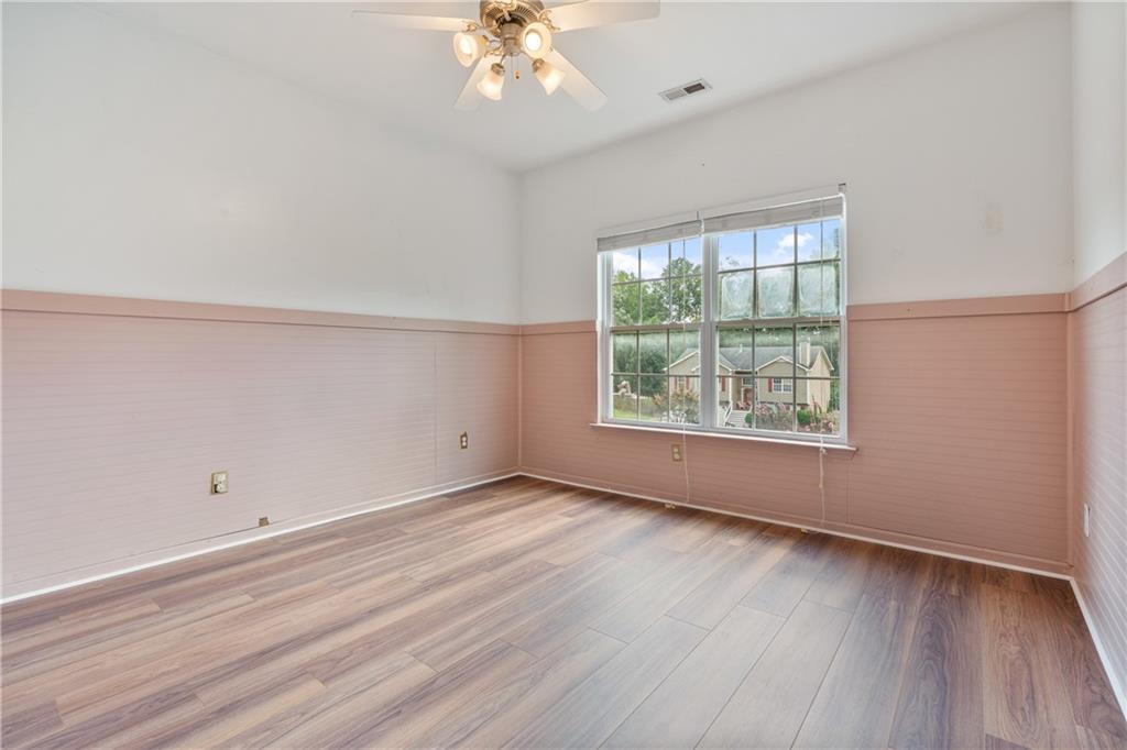 14 Bryan Springs Road Southwest Rome, GA 30165 - Photo 13 of 40 an empty room with wooden floor and windows