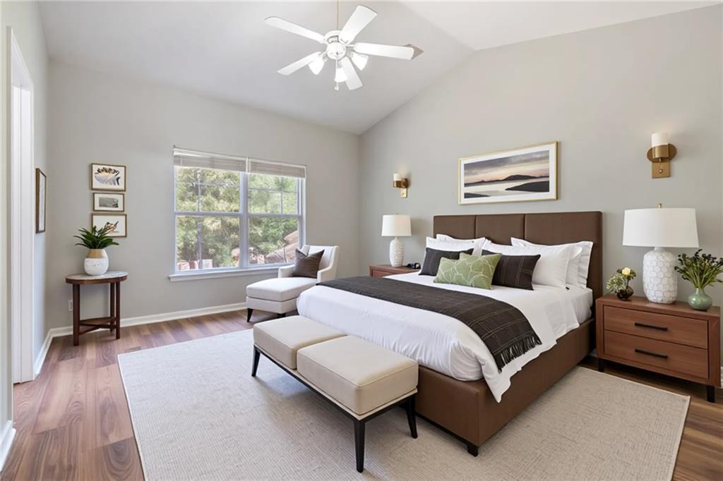 14 Bryan Springs Road Southwest Rome, GA 30165 - Photo 17 of 40 a spacious bedroom with a bed and a chandelier