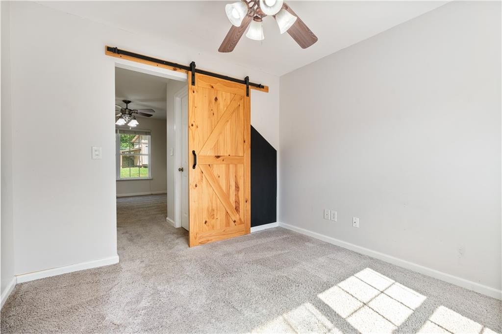 14 Bryan Springs Road Southwest Rome, GA 30165 - Photo 24 of 40 an empty room with chandelier fan and windows