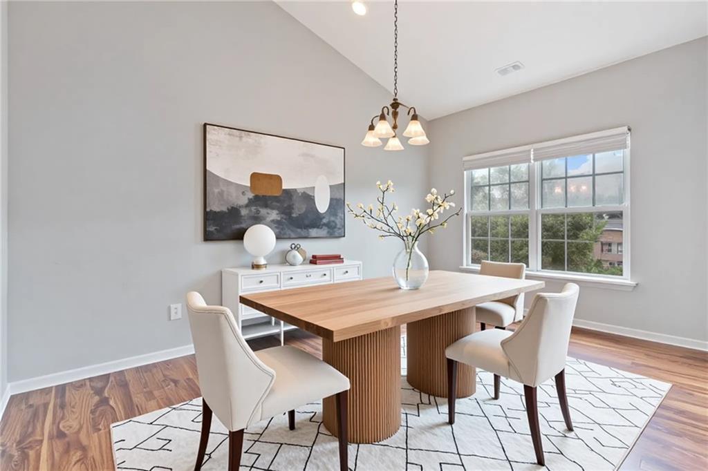 14 Bryan Springs Road Southwest Rome, GA 30165 - Photo 5 of 40 a view of a dining room with furniture a chandelier and wooden floor