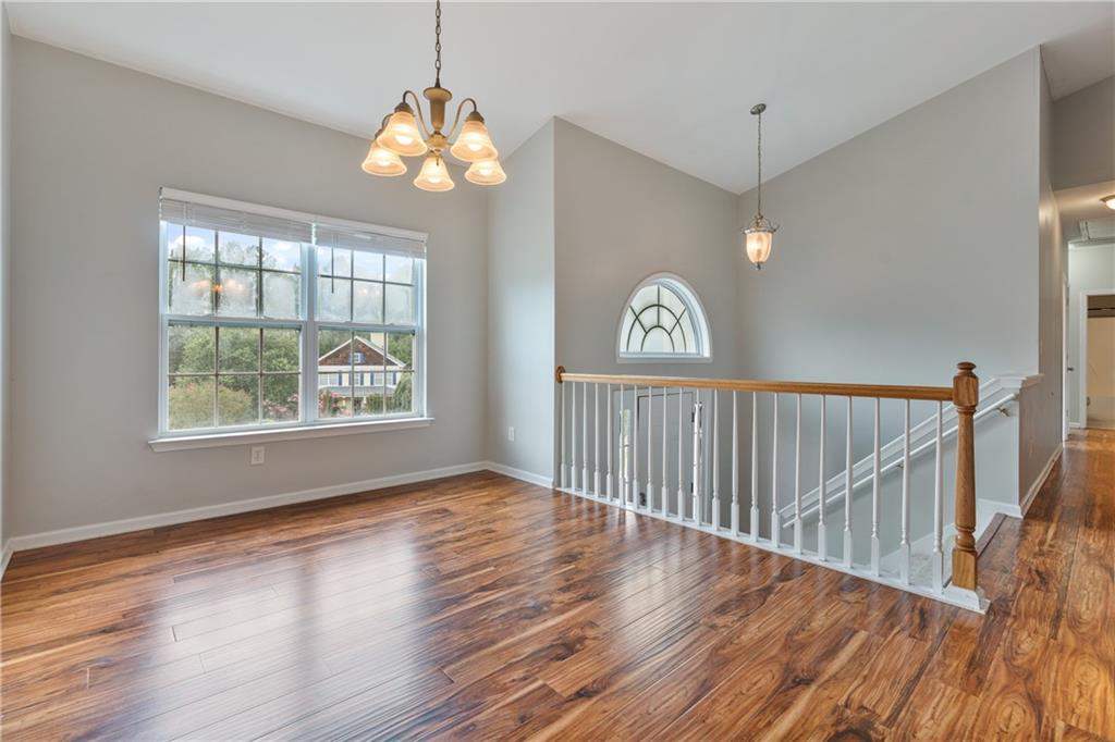 14 Bryan Springs Road Southwest Rome, GA 30165 - Photo 7 of 40 an empty room with wooden floor fan and windows