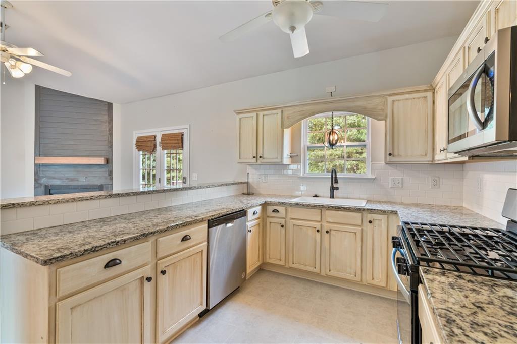 14 Bryan Springs Road Southwest Rome, GA 30165 - Photo 10 of 40 a kitchen with a sink stove and cabinets