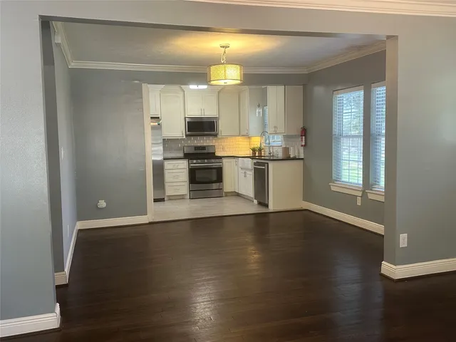 a kitchen with a refrigerator and a stove top oven