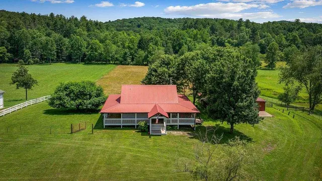 a aerial view of a house with a yard table and chairs