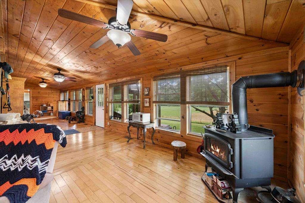 332 Night Lane Epworth, GA 30541 - Photo 29 of 84 a living room with furniture a wooden floor and a floor to ceiling window