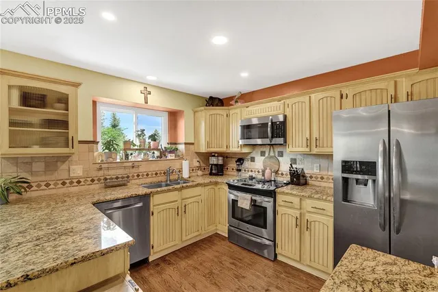 a kitchen with a sink stove and refrigerator