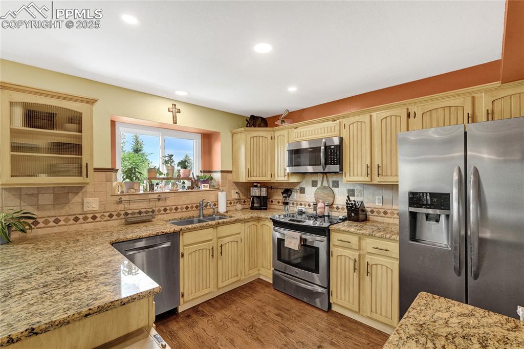 35 Lowick Drive Colorado Springs, CO 80906 - Photo 11 of 32 a kitchen with a sink stove and refrigerator