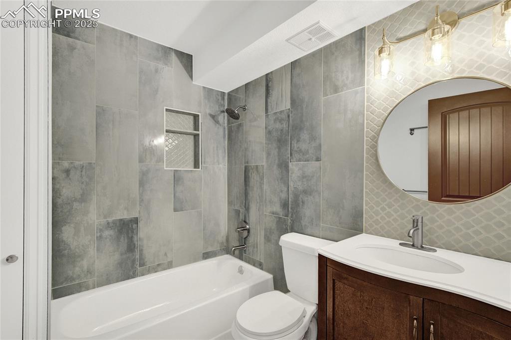 35 Lowick Drive Colorado Springs, CO 80906 - Photo 12 of 32 a bathroom with a sink toilet a shower and a mirror