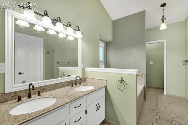 a bathroom with a sink vanity and a mirror