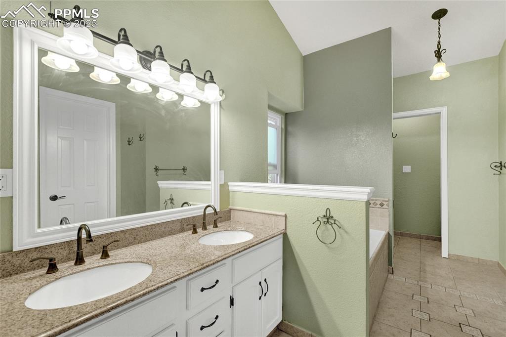 35 Lowick Drive Colorado Springs, CO 80906 - Photo 23 of 32 a bathroom with a sink vanity and a mirror
