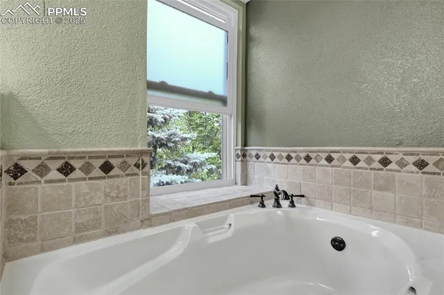 a bathroom with a bathtub and a sink