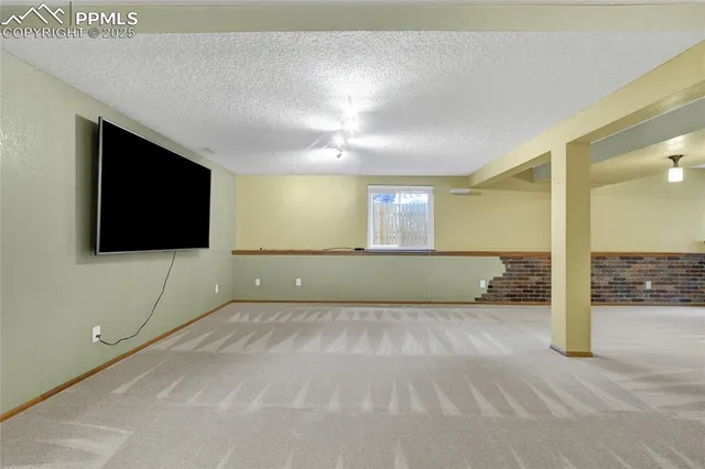 a view of an empty room with a fireplace
