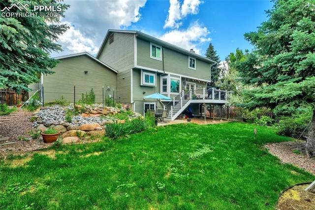 a view of a backyard with a sitting area and slide