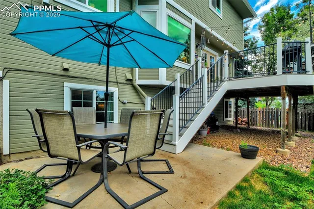 a roof deck with couches and potted plants