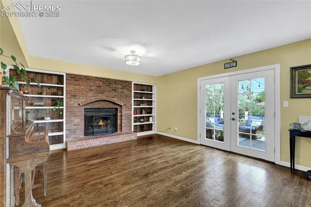 a view of an empty room with a fireplace and a window