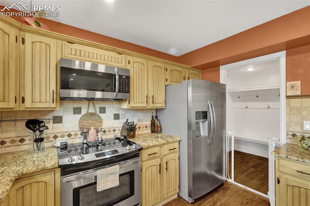 35 Lowick Drive Colorado Springs, CO 80906 - Photo 8 of 32 a kitchen with stainless steel appliances granite countertop a refrigerator stove top oven a sink and dishwasher