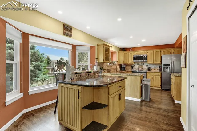 a kitchen with sink stove and refrigerator