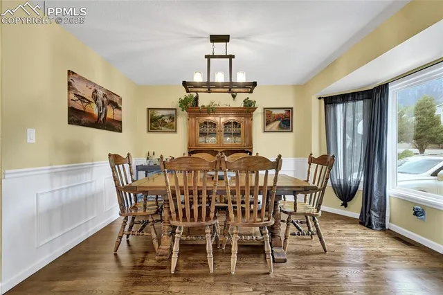 a view of a dining room with furniture window and wooden floor
