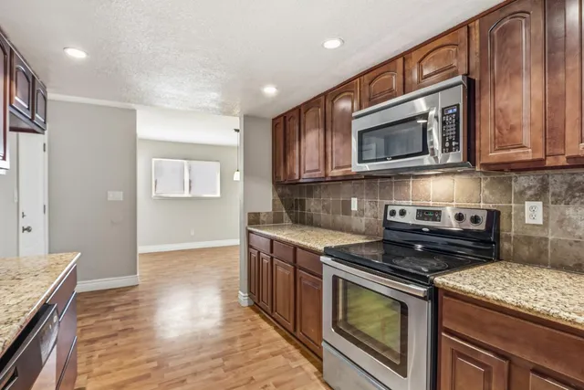 a kitchen with a sink and a wooden cabinets