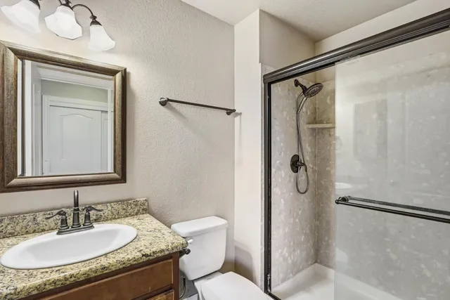 an empty room with a ceiling fan and a window