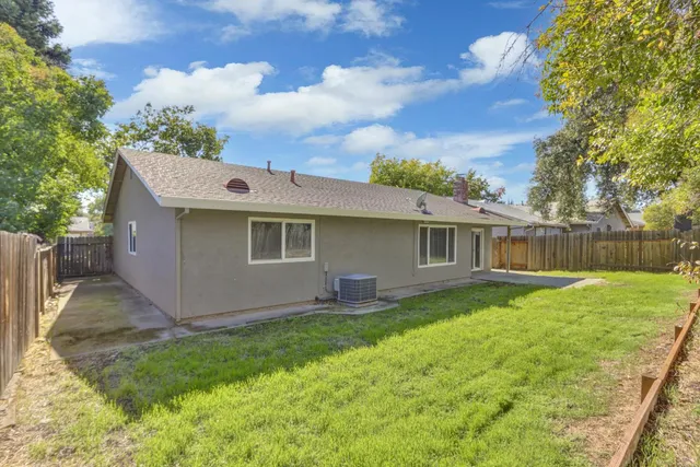a view of a house with a yard and garage