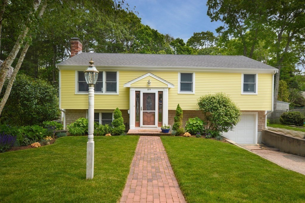 89 Emerson Way Barnstable, MA 02632 - Photo 2 of 26 a front view of a house with garden