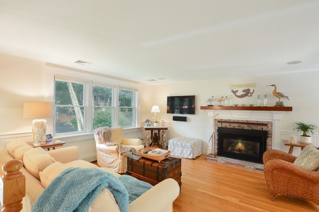 89 Emerson Way Barnstable, MA 02632 - Photo 5 of 26 a living room with furniture a fireplace and a flat screen tv