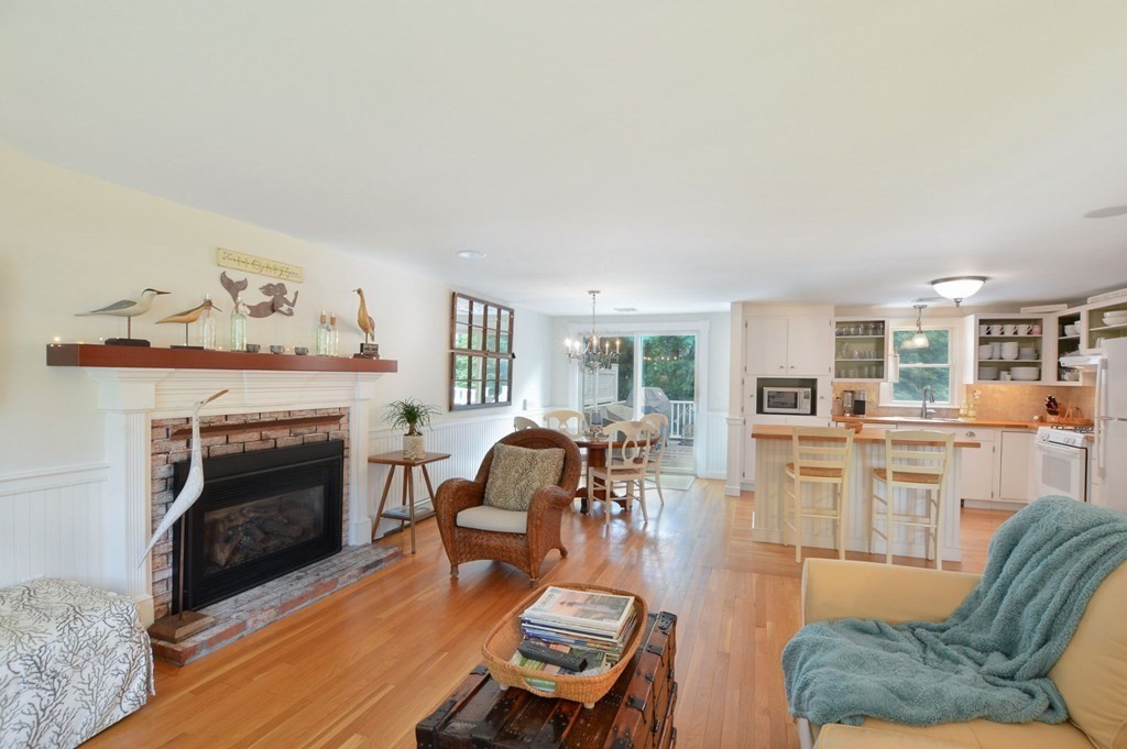 89 Emerson Way Barnstable, MA 02632 - Photo 6 of 26 a living room with furniture fireplace and kitchen view