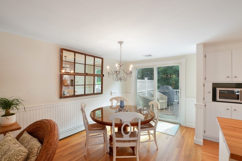 89 Emerson Way Barnstable, MA 02632 - Photo 7 of 26 a dining room with furniture a chandelier and wooden floor