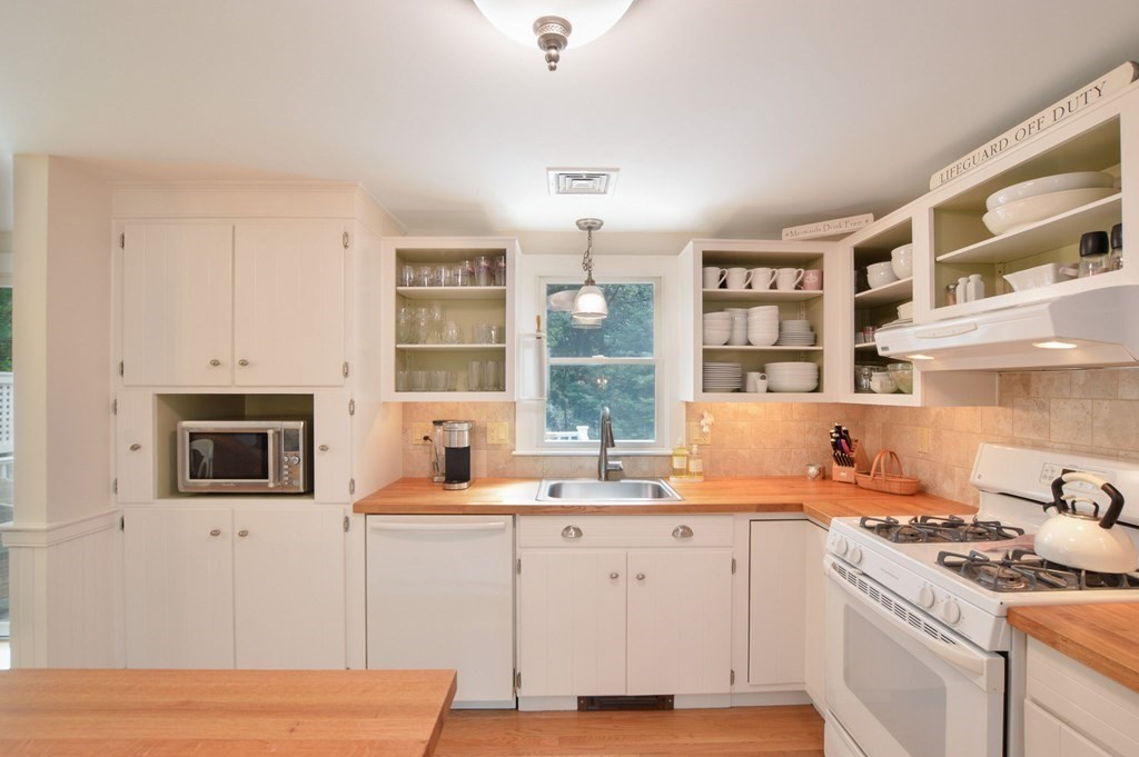 89 Emerson Way Barnstable, MA 02632 - Photo 10 of 26 a kitchen that has a lot of cabinets in it and wooden floors