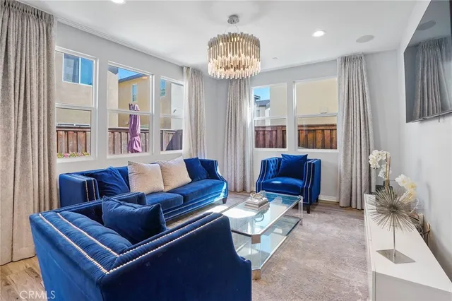 a living room with furniture a chandelier and a piano