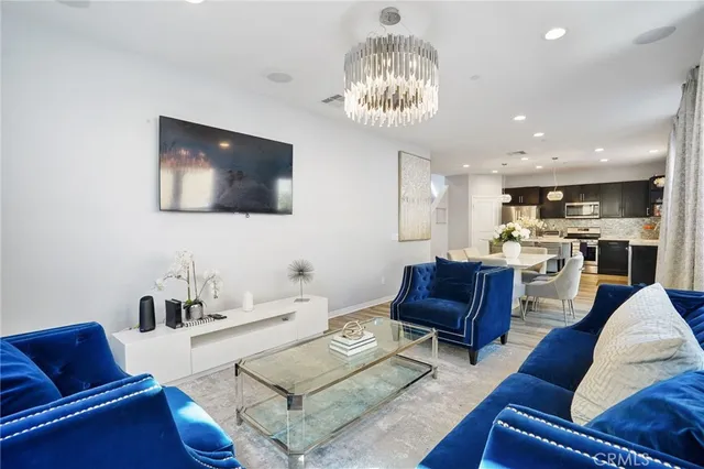 a living room with furniture and a chandelier
