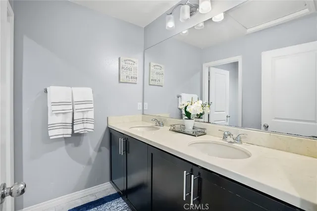 a bathroom with a sink double vanity and a mirror