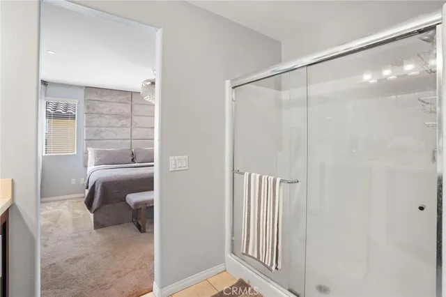 a bathroom with a glass shower door and a bathtub