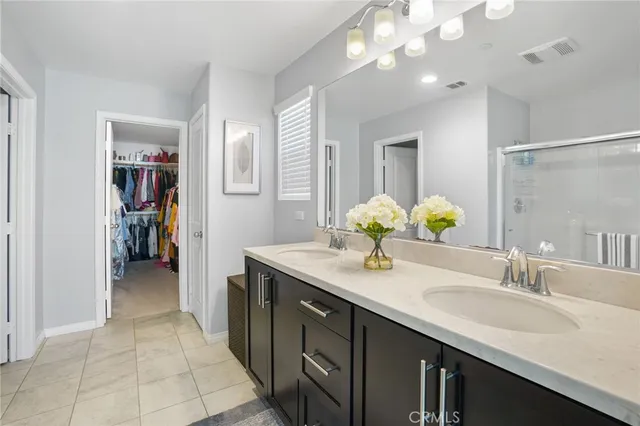 a bathroom with a sink double vanity and a mirror