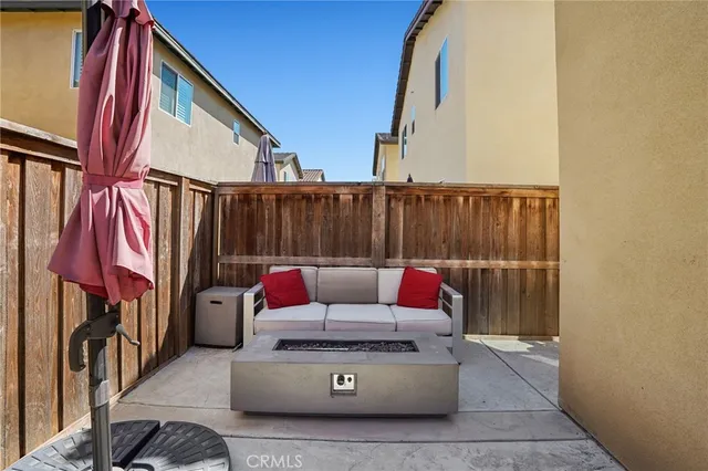 a view of a couches and dinning table in the balcony