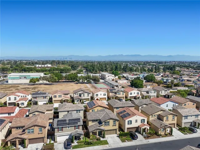 an aerial view of residential houses with city view