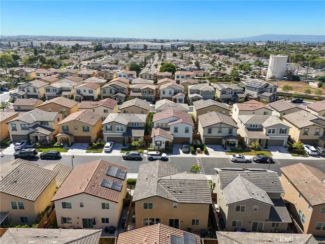 an aerial view of a residential houses with city view