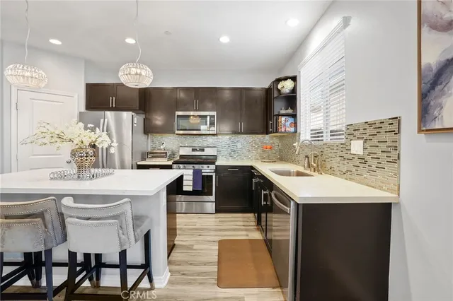 a kitchen with a sink stainless steel appliances and cabinets
