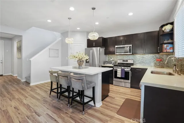 a large kitchen with a table and chairs
