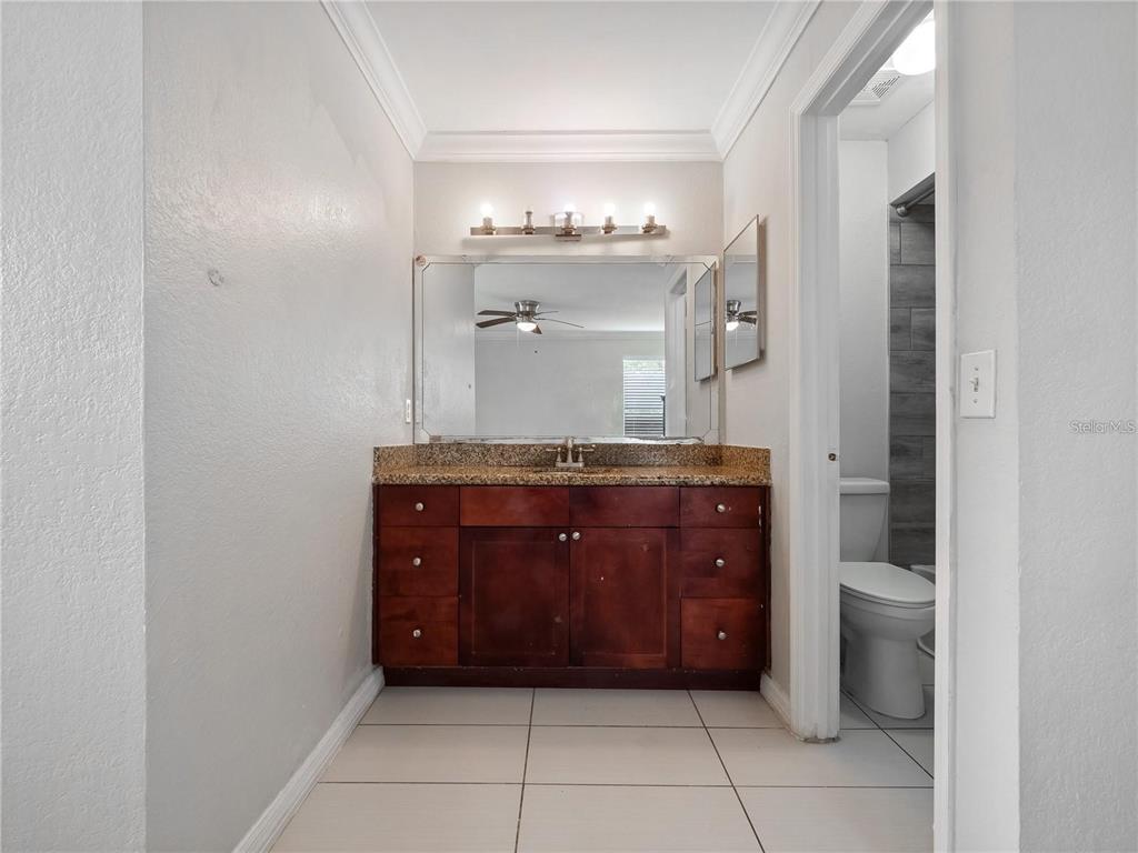5144 Conroy Road, Unit 27 Orlando, FL 32811 - Photo 11 of 20 a bathroom with a vanity and a mirror