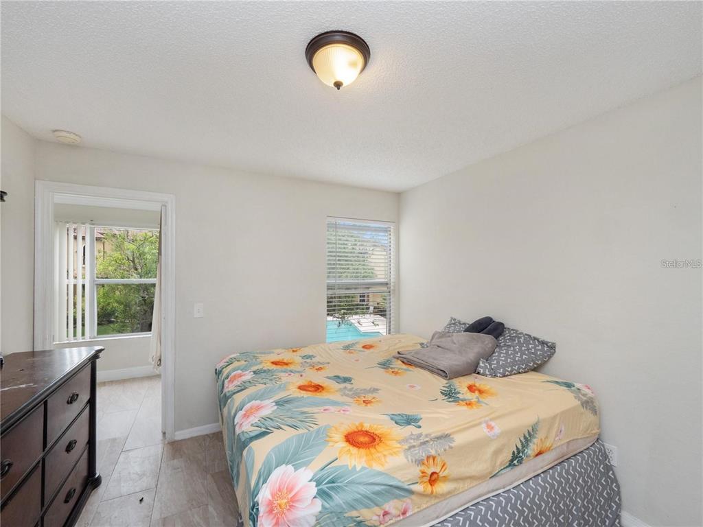5144 Conroy Road, Unit 27 Orlando, FL 32811 - Photo 13 of 20 a bedroom with a bed and a window