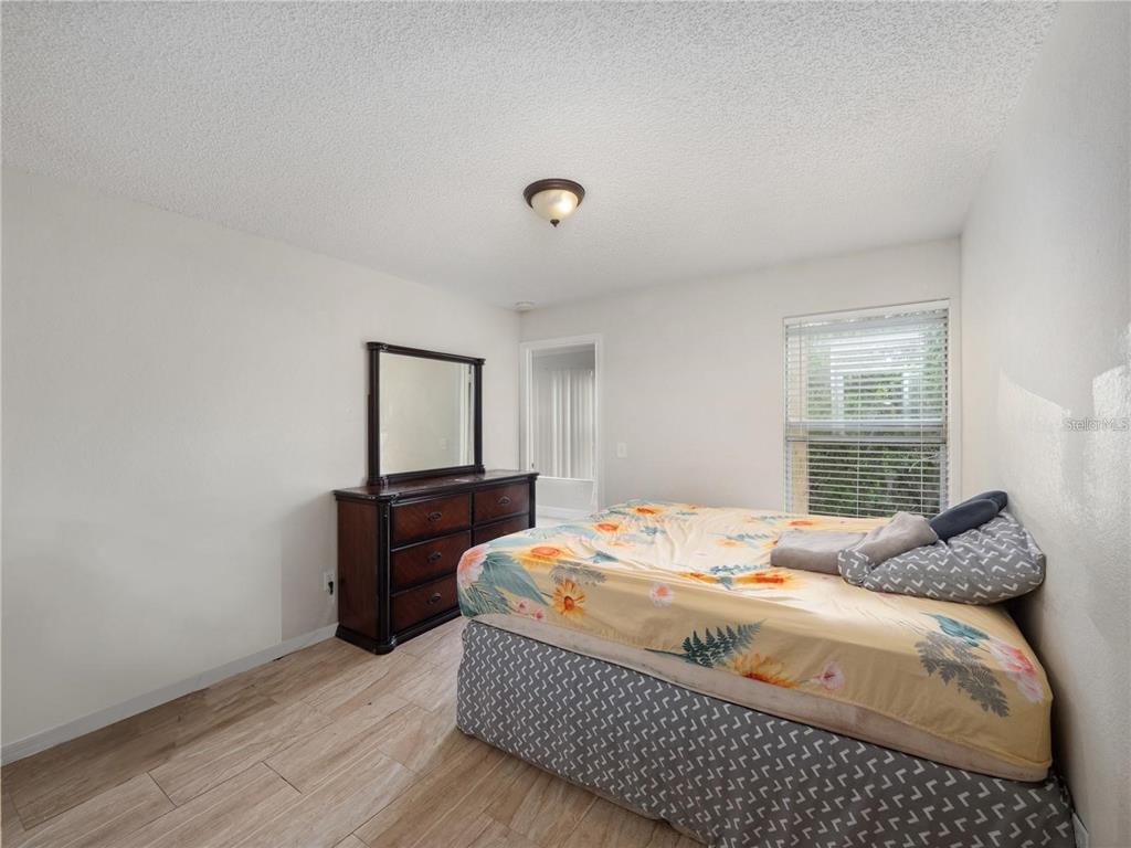 5144 Conroy Road, Unit 27 Orlando, FL 32811 - Photo 14 of 20 a bedroom with a bed and window
