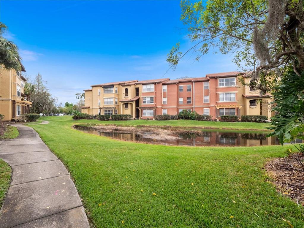 5144 Conroy Road, Unit 27 Orlando, FL 32811 - Photo 20 of 20 a view of a house with a big yard
