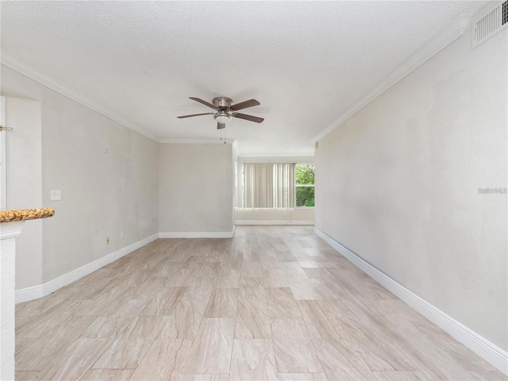 5144 Conroy Road, Unit 27 Orlando, FL 32811 - Photo 2 of 20 wooden floor in an empty room with a window