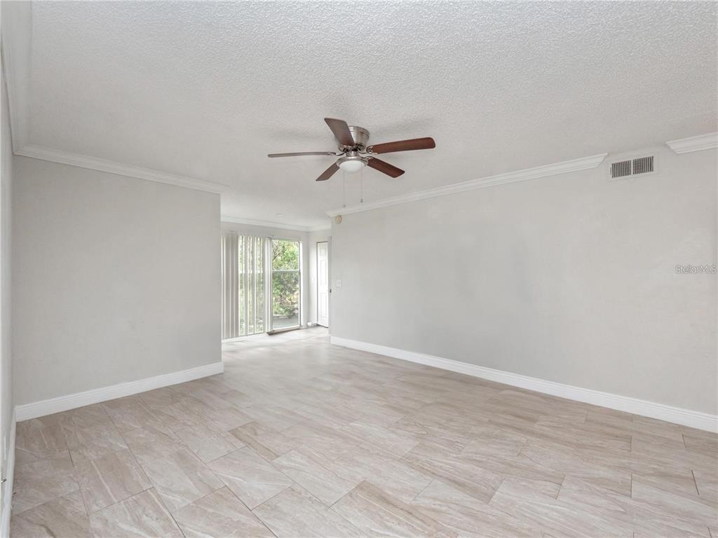 5144 Conroy Road, Unit 27 Orlando, FL 32811 - Photo 3 of 20 a view of an empty room with a window